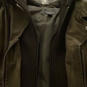 Short moto jacket with charcoal body and imitation leather sleeves.